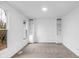 Bright, neutral living room showcasing built-in shelves and large windows for abundant natural light at 12878 Mayfair Ln, Carmel, IN 46032