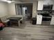 View of kitchen featuring an eat-in table, stainless steel appliances, and modern flooring at 1408 Holland St, Noblesville, IN 46060