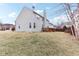 View of a well-maintained backyard with a deck and traditional two-story house at 14402 Wolverton Way, Fishers, IN 46037