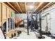 An unfinished basement with exposed wood on the ceiling and a weight lifting machine at 14402 Wolverton Way, Fishers, IN 46037