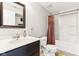 A bathroom featuring a shower and tub, a toilet, a sink, and a dark-stained cabinet at 14402 Wolverton Way, Fishers, IN 46037