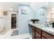 This primary bathroom boasts modern double sink vanity, granite countertop, and walk-in closet at 14402 Wolverton Way, Fishers, IN 46037