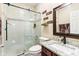 Bathroom showcasing a glass shower, granite countertops, and a dark wood vanity at 14402 Wolverton Way, Fishers, IN 46037