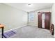 This bedroom features neutral walls, plush carpet, and a window at 14402 Wolverton Way, Fishers, IN 46037