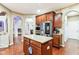 Bright kitchen featuring wooden cabinets, granite counters, stainless appliances, and hardwood floors at 14402 Wolverton Way, Fishers, IN 46037