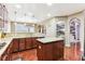 Modern kitchen with granite countertops, island, and hardwood floors at 14402 Wolverton Way, Fishers, IN 46037