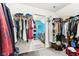 A closet with clothes hanging on racks and a washer and dryer visible through the doorway at 14402 Wolverton Way, Fishers, IN 46037