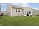 Exterior view of a home with a green lawn, patio, neutral-colored siding, and a grill at 16613 Grappa Trl, Fishers, IN 46037