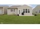 Exterior of a house with a patio, grill, manicured green lawn, and light-colored vinyl siding at 16613 Grappa Trl, Fishers, IN 46037