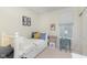 Cozy bedroom with a white bed, blue and gold pillows, a small desk, and a window with blinds at 16613 Grappa Trl, Fishers, IN 46037