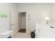 Neutral bedroom with a bed, bedside table, coat rack, and light entering from the window at 16613 Grappa Trl, Fishers, IN 46037