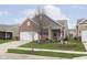 Traditional home with a well-manicured lawn, brick accents, and neutral siding at 16613 Grappa Trl, Fishers, IN 46037