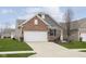 Well-maintained home with a two-car garage and a freshly landscaped front yard at 16613 Grappa Trl, Fishers, IN 46037