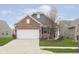 Charming brick home with a two-car garage and a well-maintained front yard at 16613 Grappa Trl, Fishers, IN 46037
