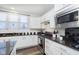 Well-lit kitchen featuring white cabinets, stainless steel appliances, granite countertops, and tiled backsplash at 16613 Grappa Trl, Fishers, IN 46037