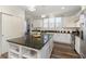 Spacious kitchen island with granite countertop, ample storage, and white cabinetry throughout at 16613 Grappa Trl, Fishers, IN 46037