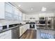 Modern kitchen with white cabinets, stainless steel appliances, and granite countertops at 16613 Grappa Trl, Fishers, IN 46037