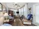 Cozy living room with a ceiling fan, large windows, and comfortable seating at 16613 Grappa Trl, Fishers, IN 46037