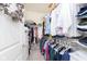 Organized walk-in closet with clothes hanging on rods, shelves, and an abundance of storage space at 16613 Grappa Trl, Fishers, IN 46037