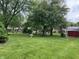 Expansive backyard featuring lush lawn, mature trees, and ample space for outdoor activities and relaxation at 1701 Beech N Dr, Plainfield, IN 46168