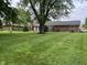 Large backyard with lush green lawn and mature trees, perfect for outdoor activities at 1701 Beech N Dr, Plainfield, IN 46168