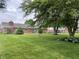 Expansive backyard with lush green lawn and mature trees, offering a serene outdoor space at 1701 Beech N Dr, Plainfield, IN 46168
