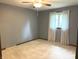 Comfortable bedroom with gray walls, ceiling fan, plush carpet, and a window at 1701 Beech N Dr, Plainfield, IN 46168