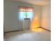 Bright, carpeted bedroom with a window offering natural light and a cozy lamp at 1701 Beech N Dr, Plainfield, IN 46168