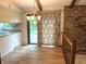 Dining area with hardwood floors, sliding glass door, brick wall, and chandelier at 1701 Beech N Dr, Plainfield, IN 46168