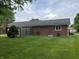 Brick home exterior featuring well-maintained landscaping, a fenced yard, and a cozy atmosphere at 1701 Beech N Dr, Plainfield, IN 46168