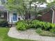 A covered front porch provides a cozy entry, enhanced with lush fern landscaping at 1701 Beech N Dr, Plainfield, IN 46168