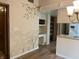 Hallway with painted faux brick wall, decorative tree design and entry to the kitchen at 1701 Beech N Dr, Plainfield, IN 46168