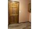 Hallway entrance from the kitchen with wood door and adjacent cabinets at 1701 Beech N Dr, Plainfield, IN 46168