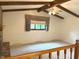 Living room featuring vaulted ceilings, wood beams, fireplace, and a view to the landing at 1701 Beech N Dr, Plainfield, IN 46168