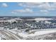An aerial view of a neighborhood with modern homes, pond and snow-covered landscape at 20170 Edwick Dr, Westfield, IN 46074