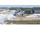 Aerial view of a home's backyard with a view of the neighborhood and a pond covered in snow at 20170 Edwick Dr, Westfield, IN 46074
