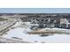 Aerial view of a neighborhood featuring homes with a pond and a partly cloudy sky on a sunny day at 20170 Edwick Dr, Westfield, IN 46074