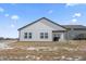 The backyard shows off the property's white siding and covered patio, perfect for entertaining at 20170 Edwick Dr, Westfield, IN 46074