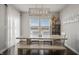 Dining area with an expansive wooden table, bench seating, and bright windows with farmland views at 20170 Edwick Dr, Westfield, IN 46074