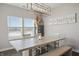 Bright dining area with large windows, modern lighting, and a stylish, rustic dining table with bench seating at 20170 Edwick Dr, Westfield, IN 46074