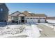 Charming single-story home features a three-car garage and a well-manicured front lawn covered in snow at 20170 Edwick Dr, Westfield, IN 46074