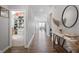 Bright hallway with hardwood floors, closet and decorated table, leading to an open-concept living space at 20170 Edwick Dr, Westfield, IN 46074