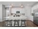 Bright kitchen with stainless steel appliances, white cabinets, pendant lighting, and breakfast bar with stools at 20170 Edwick Dr, Westfield, IN 46074