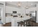 Bright kitchen with stainless steel appliances, white cabinets, pendant lighting, and breakfast bar with stools at 20170 Edwick Dr, Westfield, IN 46074