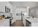 Bright kitchen with stainless steel appliances, white cabinets, and a large island with sink at 20170 Edwick Dr, Westfield, IN 46074