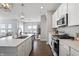 Bright kitchen with stainless steel appliances, white cabinets, pendant lighting, and island with sink at 20170 Edwick Dr, Westfield, IN 46074