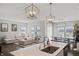 Open concept living room and kitchen with eat-in dining area, a large couch, and ample natural light at 20170 Edwick Dr, Westfield, IN 46074