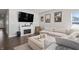 Comfortable living room showcasing the electric fireplace, contemporary decor, and plush sectional sofa at 20170 Edwick Dr, Westfield, IN 46074