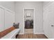 Mud room with a bench and storage, leading to a laundry room with modern washer and dryer units at 20170 Edwick Dr, Westfield, IN 46074