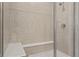 Tiled walk-in shower with a built-in bench seat and glass enclosure at 20170 Edwick Dr, Westfield, IN 46074